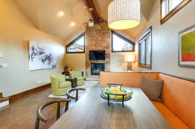 a living room with a couch and a table at Frisco Condo with Rooftop Deck Walk to Main St! in Frisco