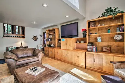 a living room filled with furniture and a flat screen tv at Lakefront Fort Collins Townhome, Only 3 Mi to CSU! in Fort Collins
