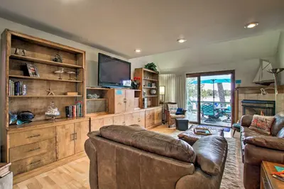 a living room with a couch and a flat screen tv at Lakefront Fort Collins Townhome, Only 3 Mi to CSU! in Fort Collins