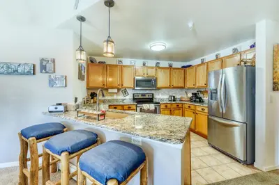 a kitchen with wooden cabinets and a stainless steel refrigerator at Revett Retreat in Breckenridge