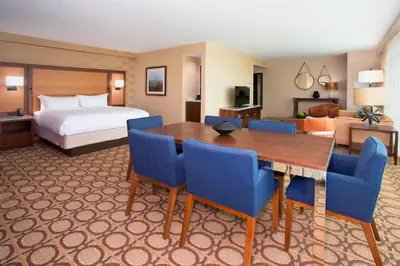 a hotel room with a bed and a table and chairs at Denver Marriott Westminster in Westminster