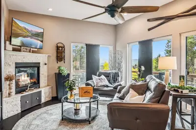 a living room with a couch and a fireplace at Treehouse 1BR with Hot Tub home in Black Hawk