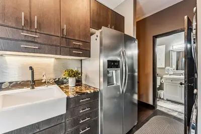 a kitchen with a sink and a refrigerator at Treehouse 1BR with Hot Tub home in Black Hawk
