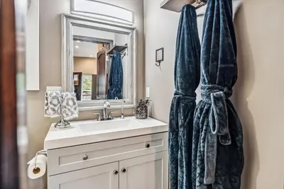 a bathroom with a sink and a mirror at Treehouse 1BR with Hot Tub home in Black Hawk