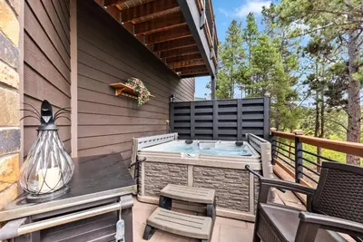a patio with a hot tub on a deck at Treehouse 1BR with Hot Tub home in Black Hawk