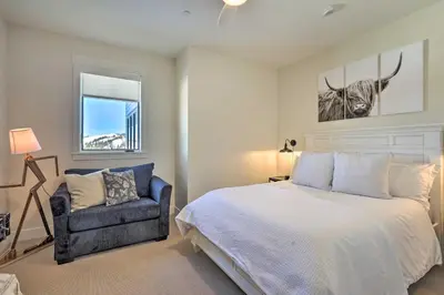a bedroom with a bed and a chair at Condo with View - 1 Block to Main St - 4 Mi to Ski! in Winter Park