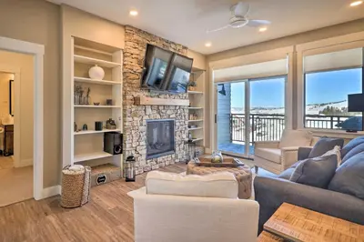a living room with a couch and a fireplace at Condo with View - 1 Block to Main St - 4 Mi to Ski! in Winter Park