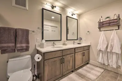 a bathroom with a sink and a toilet and a mirror at Condo with View - 1 Block to Main St - 4 Mi to Ski! in Winter Park