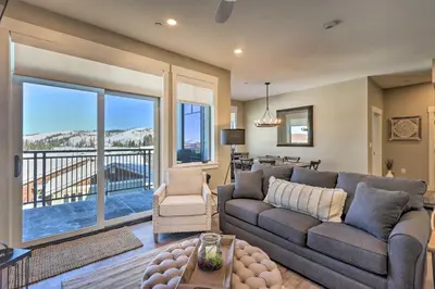 a living room with a couch and a large window at Condo with View - 1 Block to Main St - 4 Mi to Ski! in Winter Park
