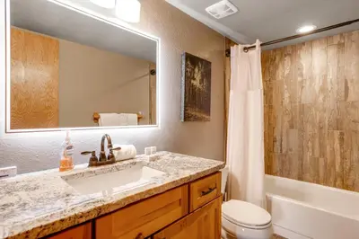 a bathroom with a sink and a toilet and a mirror at Snowdance Manor 403 in Keystone