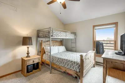 a bedroom with a bunk bed and a desk at Snowdance Manor 403 in Keystone