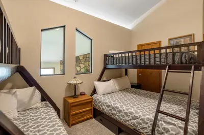 a bedroom with two bunk beds and a bed sidx sidx sidx sidx at Snowdance Manor 403 in Keystone