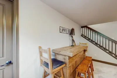 a home office with a desk and a staircase at Tall Timber Getaway in Granby