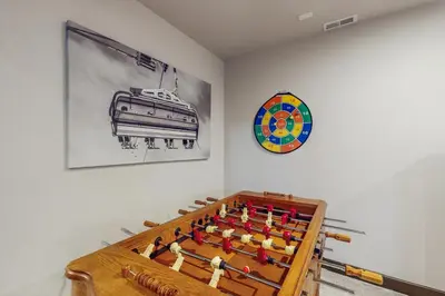 a room with a chess board and a clock on the wall at Tall Timber Getaway in Granby