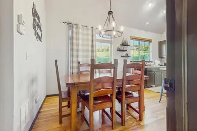 a kitchen and dining room with a table and chairs at Tall Timber Getaway in Granby