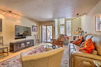 a living room with a couch and a tv and a fireplace at 7 Mi to Ski Waterfront Townhome in Frisco! in Frisco