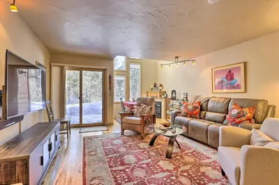 a living room with a couch and a table at 7 Mi to Ski Waterfront Townhome in Frisco! in Frisco