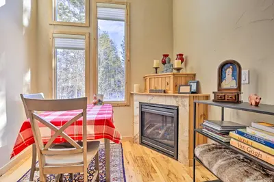 a living room with a table and a fireplace at 7 Mi to Ski Waterfront Townhome in Frisco! in Frisco