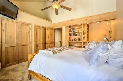 a bedroom with a large bed with a ceiling fan at 7 Mi to Ski Waterfront Townhome in Frisco! in Frisco