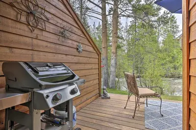 a grill and a chair on a wooden deck at 7 Mi to Ski Waterfront Townhome in Frisco! in Frisco