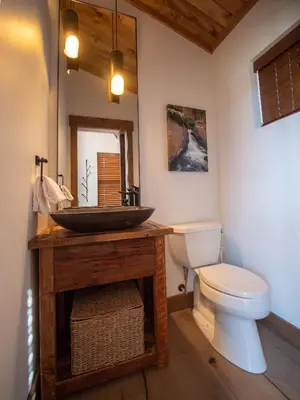 a bathroom with a sink and a toilet at Chic Retreat – Indoor/Outdoor Fireplace, Private Jacuzzi, Great Location! in Estes Park