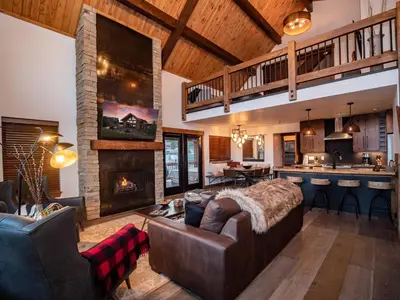 a living room with a couch and a fireplace at Chic Retreat – Indoor/Outdoor Fireplace, Private Jacuzzi, Great Location! in Estes Park