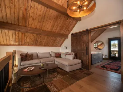 a living room with a couch and a table at Chic Retreat – Indoor/Outdoor Fireplace, Private Jacuzzi, Great Location! in Estes Park