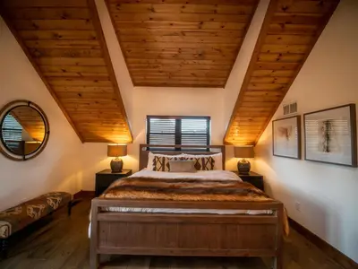 a bedroom with a bed and a wooden ceiling at Blissful Mountain Getaway – Steps to Lake Estes, Indoor/Outdoor Fireplace in Estes Park