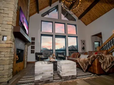 a living room with a couch and a fireplace at Blissful Mountain Getaway – Steps to Lake Estes, Indoor/Outdoor Fireplace in Estes Park