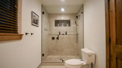 a bathroom with a shower and a toilet at Blissful Mountain Getaway – Steps to Lake Estes, Indoor/Outdoor Fireplace in Estes Park