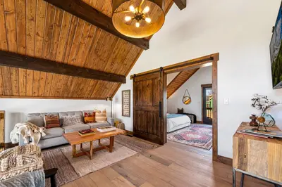 a living room with a couch and a table at The Bear's Getaway - Jacuzzi, Indoor/Outdoor Fireplace, Fantastic Location! in Estes Park