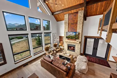 a living room with a couch and a fireplace at The Bear's Getaway - Jacuzzi, Indoor/Outdoor Fireplace, Fantastic Location! in Estes Park