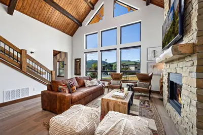 a living room with a couch and a fireplace at The Bear's Getaway - Jacuzzi, Indoor/Outdoor Fireplace, Fantastic Location! in Estes Park