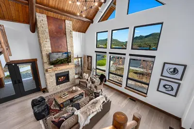a living room with a couch and a fireplace at Relax in The Rockies – Located on Lake Estes, Jacuzzi and Indoor/Outdoor Fireplace in Estes Park