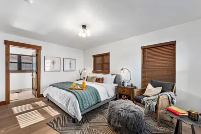a bedroom with a bed and a chair at Relax in The Rockies – Located on Lake Estes, Jacuzzi and Indoor/Outdoor Fireplace in Estes Park
