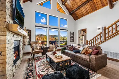 a living room with a couch and a fireplace at Relax in The Rockies – Located on Lake Estes, Jacuzzi and Indoor/Outdoor Fireplace in Estes Park
