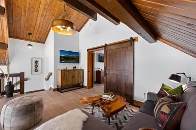 a living room with a couch and a table at Cozy & Relaxing – Indoor/Outdoor Fireplace, Jacuzzi and BBQ grill in Estes Park