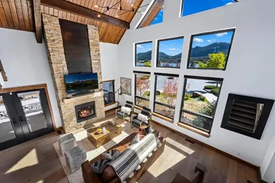 an overhead view of a living room with large windows at Cozy & Relaxing – Indoor/Outdoor Fireplace, Jacuzzi and BBQ grill in Estes Park