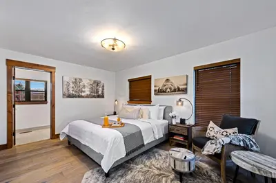 a bedroom with a bed and a table and a couch at New Log cabin, The Bears Den - 2 bedrooms, loft, 2.5 bath, jacuzzi & Fireplace in Estes Park