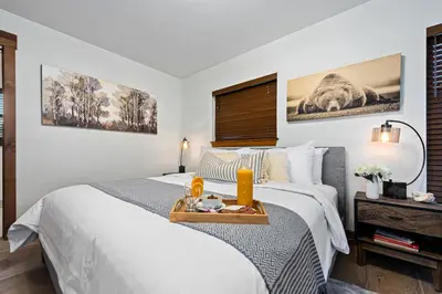 a hotel room with two beds with a tray on it at New Log cabin, The Bears Den - 2 bedrooms, loft, 2.5 bath, jacuzzi & Fireplace in Estes Park