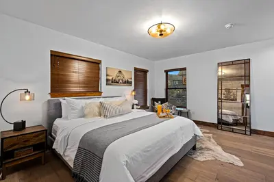 a bedroom with a large bed with a wooden headboard at New Log cabin, The Bears Den - 2 bedrooms, loft, 2.5 bath, jacuzzi & Fireplace in Estes Park