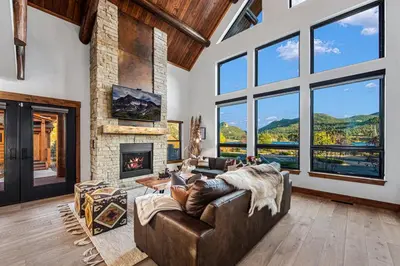 a living room with a couch and a fireplace at New Log cabin, The Bears Den - 2 bedrooms, loft, 2.5 bath, jacuzzi & Fireplace in Estes Park