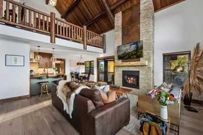 a living room with a couch and a fireplace at New Log cabin, The Bears Den - 2 bedrooms, loft, 2.5 bath, jacuzzi & Fireplace in Estes Park