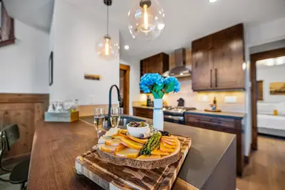 a kitchen with a counter with fruits and vegetables on it at Fly Rod Inn – Two Large Patios, Jacuzzi and Indoor/Outdoor Fireplace in Estes Park