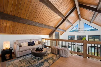 a living room with a couch and a table at End Unit - EV Charger, Fireplace & Jacuzzi in Estes Park