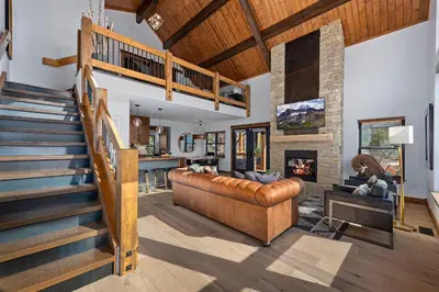 a living room with a couch and a fireplace at End Unit - EV Charger, Fireplace & Jacuzzi in Estes Park