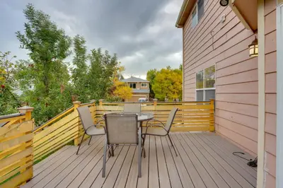 a wooden deck with a table and chairs on it at Denver Getaway Close to Downtown, Mtns, and Boulder in Thornton