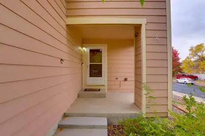 a front door of a house with a yellow door at Denver Getaway Close to Downtown, Mtns, and Boulder in Thornton
