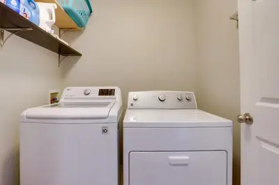 a kitchen with a stove and a washer and dryer at Denver Getaway Close to Downtown, Mtns, and Boulder in Thornton