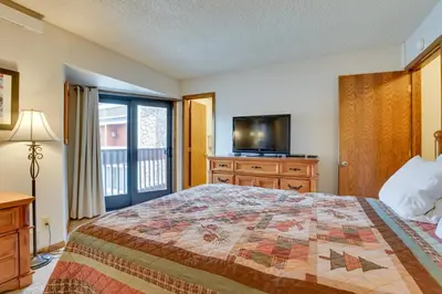 a bedroom with a bed and a tv and a window at Mtn Condo with Ski Locker and Pools - 3 Mi to Resort! in Winter Park